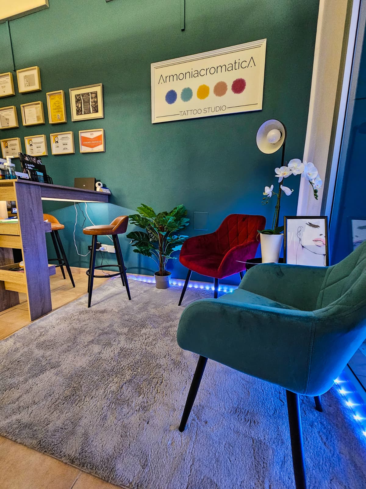 The studio waiting area, with the Armoniacromatica sign and the certificates on the wall