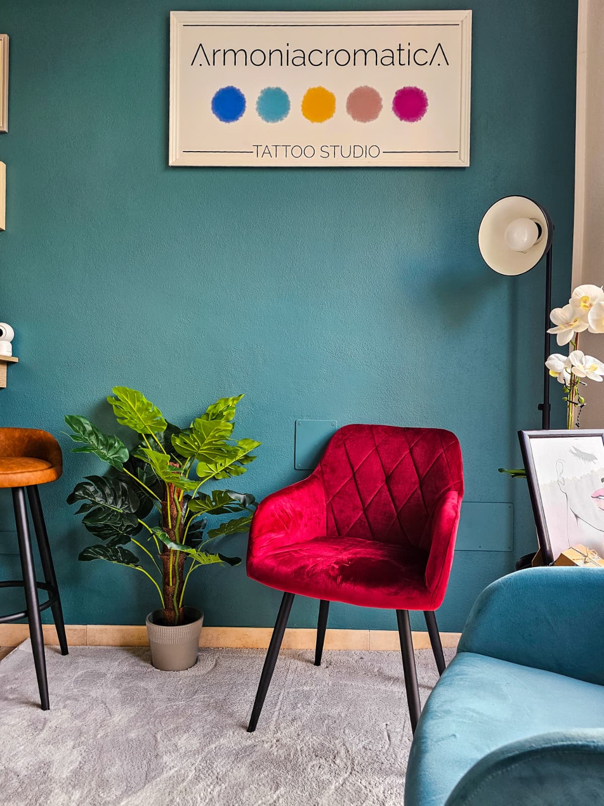 The Armoniacromatica Tattoo Studio sign above the red armchair